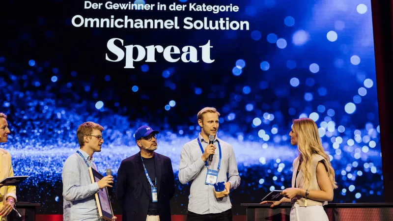 Paul Kirchbichler und Mattis Klöpper auf der Bühne des K5 Commerce Award 2025, auf der Leinwand: Gewinner in der Kategorie Omnichannel Solution, Spreat